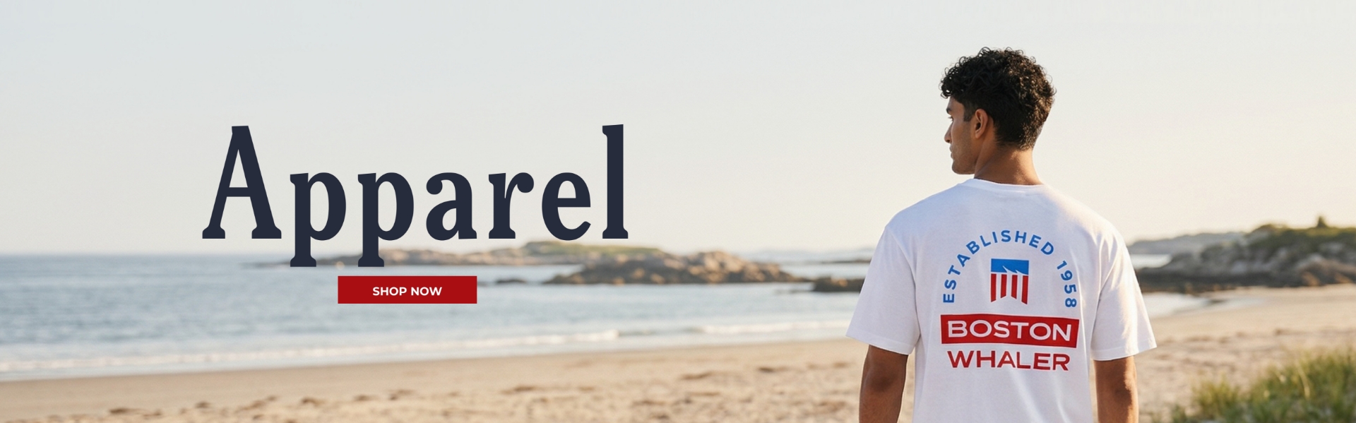 Man on beach wearing Boston Whaler shirt with Apparel text